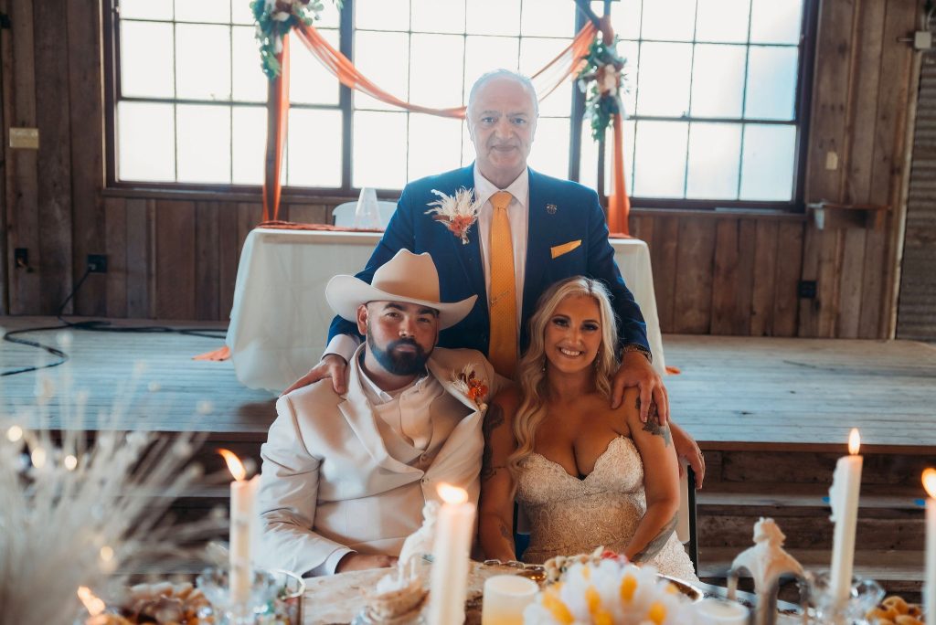 Texas Wedding Officiate Daryoush Ghashghai officiating bilingual wedding ceremony in Texas with bride and groom seated at sofreh aghd